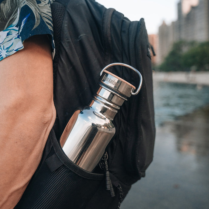 27oz-reflect-with-bamboo-cap-o5 K27SSLRF-MS-BAMBOO_reflect-bottle_backpack_lifestyle.jpg
